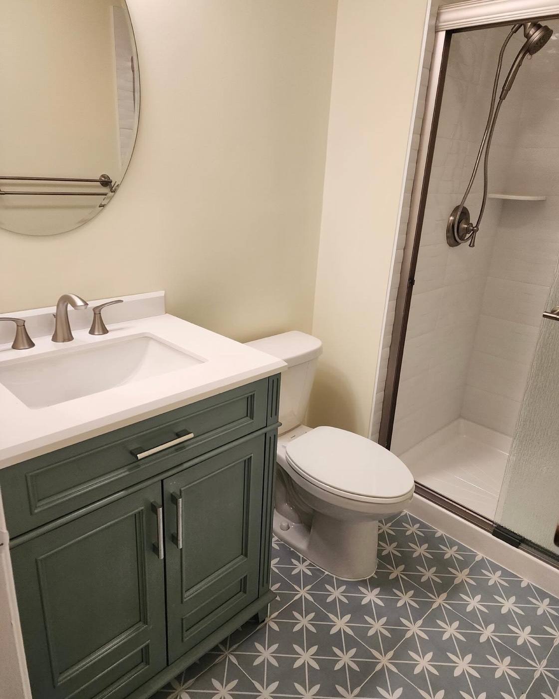 Green vanity with patterned tile floor
