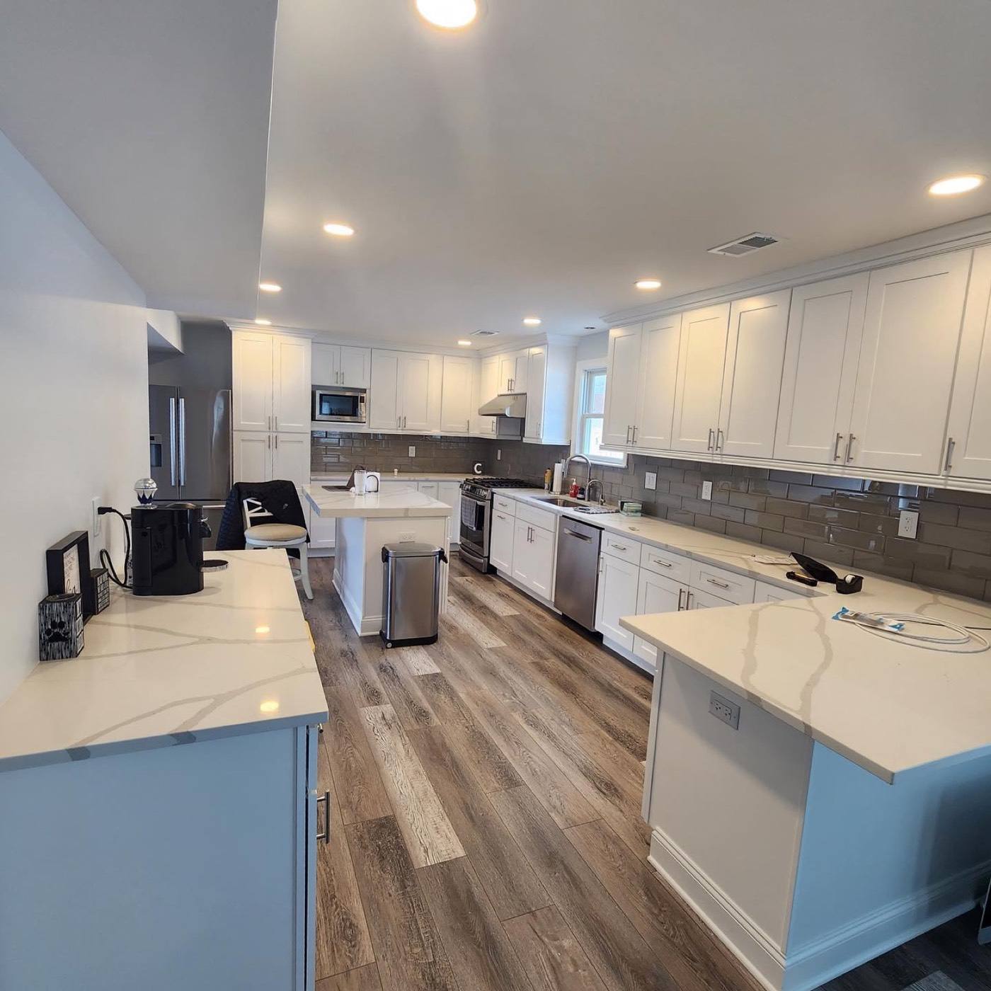Finished white shaker kitchen with a quartz island